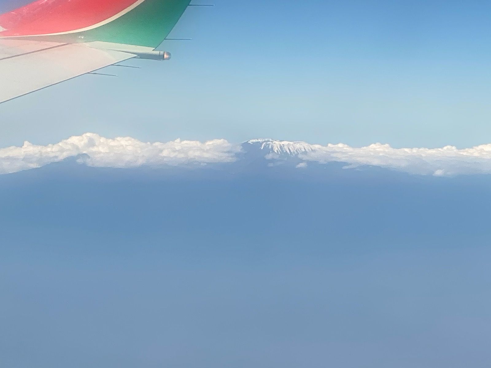 View from the plane -plane wing tip and clouds